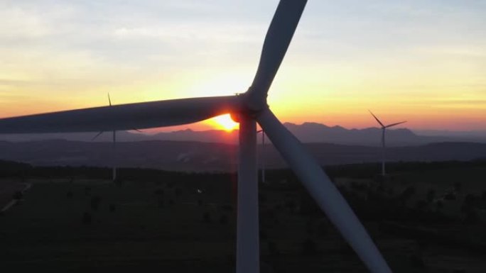 日落时风力发电机4k鸟瞰图，风车，能源生产-绿色技术。可再生能源解决方案