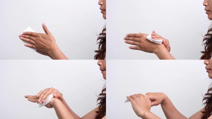 妇女用白色软组织纸或湿巾清洁双手，以防止冠状病毒新型冠状病毒肺炎病毒感染。医疗保健和医疗概念。