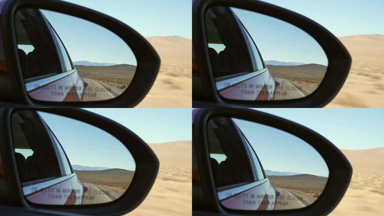 POV侧视图乘客后视镜显示开阔的沙漠道路
