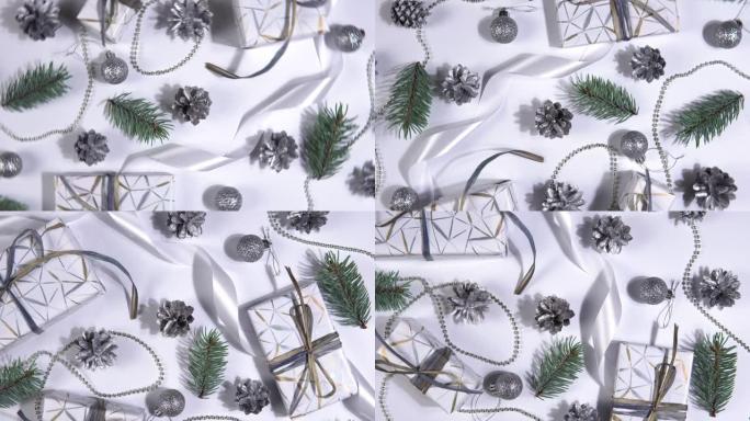 圣诞抽象背景360度旋转。白色背景上旋转的银松果、冷杉树枝和礼品盒