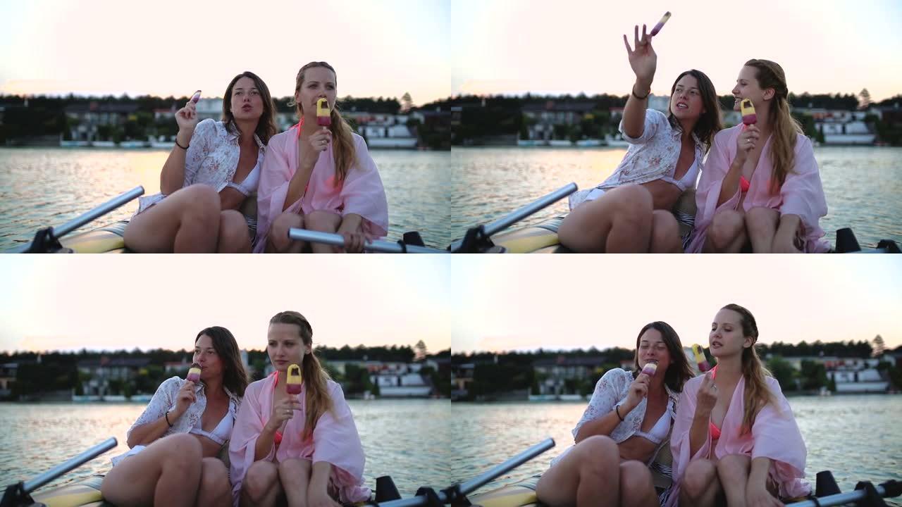 两个快乐的年轻女子坐在船上