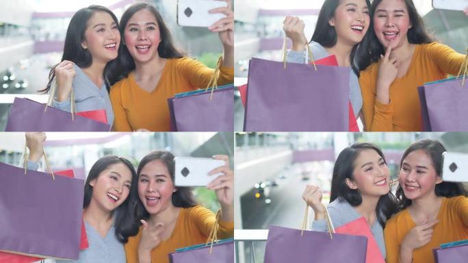 戴着口罩的亚洲女人。快乐的女人带着购物袋享受购物。女孩拿着彩色纸袋。逛商场的朋友。时间购物冠状病毒危