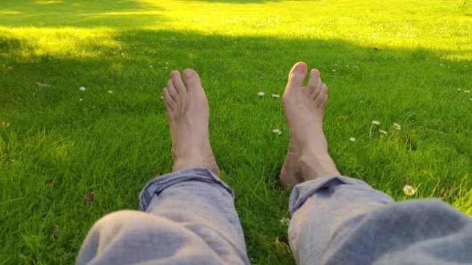 马德里西公园草地上的成年男性赤脚