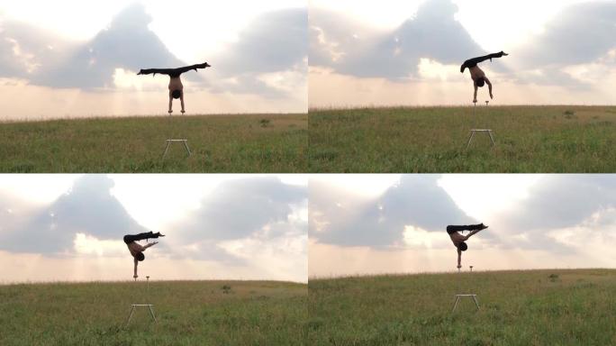 一个有运动能力的人在日落时在野外进行复杂的体操运动