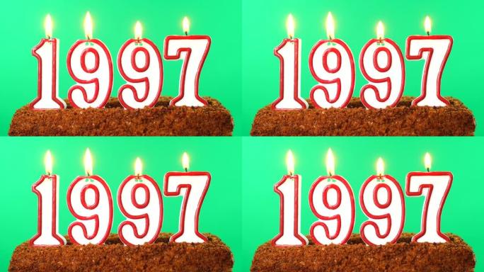 蛋糕与数字1997点燃的蜡烛。上个世纪的日期。色度键。绿屏。隔离