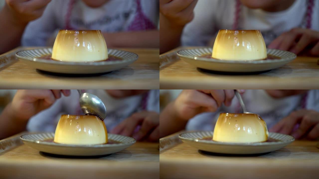 小女孩在餐馆吃甜点。盘子上的布丁特写。