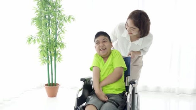残疾庇护所的亚洲女性志愿者和脑瘫男孩