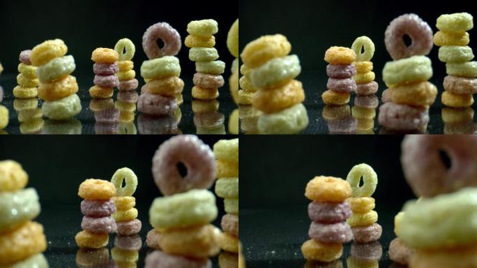 五颜六色的谷物箍排成一排在金字塔里。儿童饮食过程概念