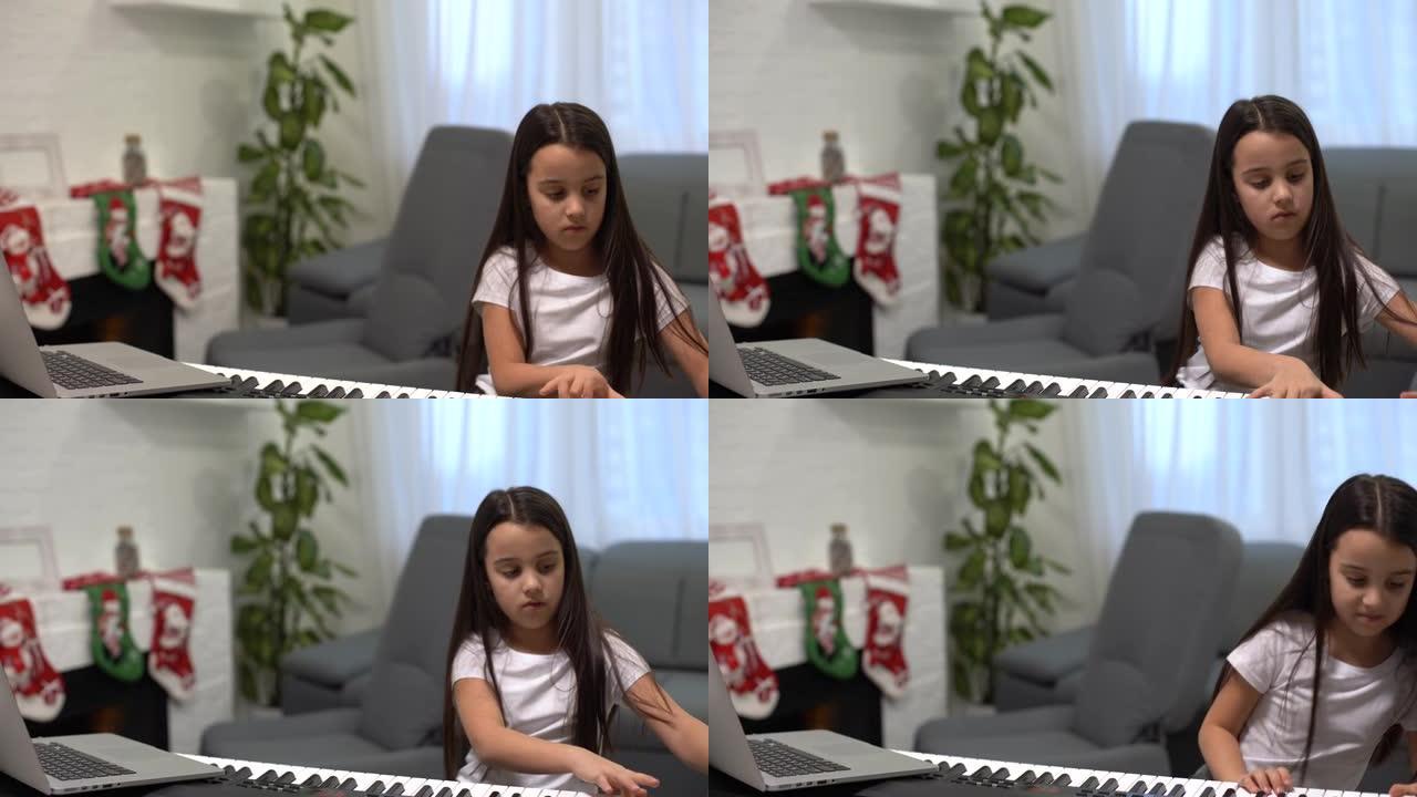 可爱的小女孩弹钢琴，背景装饰圣诞节。大流行期间的圣诞节庆祝活动