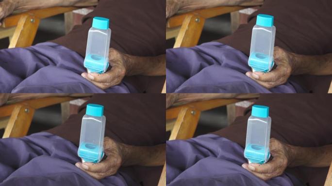 亚洲男子手持哮喘吸入器
