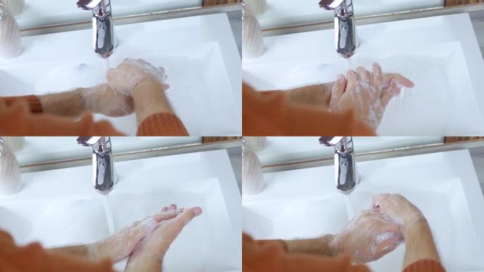 一个年轻人在自来水下用肥皂洗手，这样新型冠状病毒肺炎就不会被感染，保健，特写