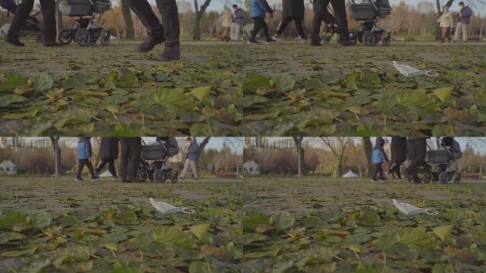 在公园散步时把口罩扔到地上的那个人。环境污染。医疗废物污染。