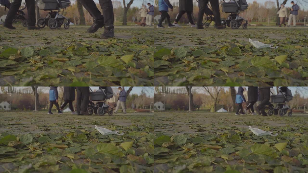 在公园散步时把口罩扔到地上的那个人。环境污染。医疗废物污染。