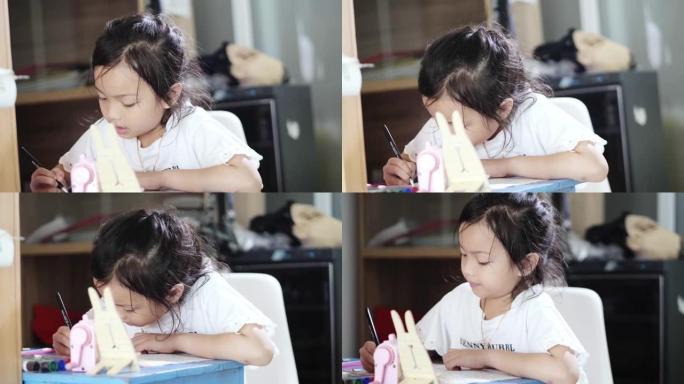 亚洲女孩在家做作业，在家上学的概念。
