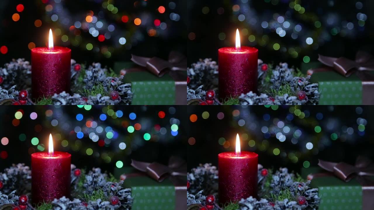 在人造雪的背景下，圣诞节之夜点燃的蜡烛