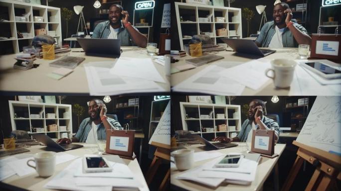 微笑的非洲商人在黑暗的同事中谈论手机。