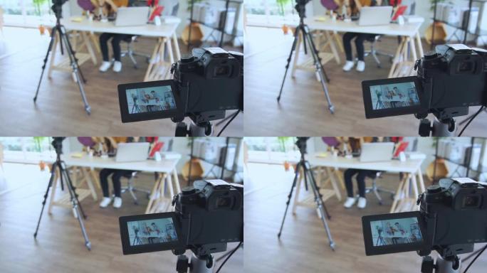 年轻的亚洲夫妇博主录制vlog视频，有影响力的人在工作室用化妆化妆品在社交媒体上直播，在家学习的在线