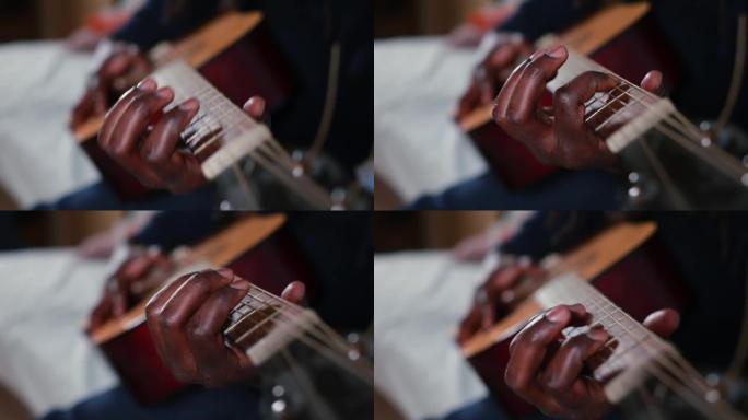 男子录制音乐创作订阅者黑手击打弦吉他。