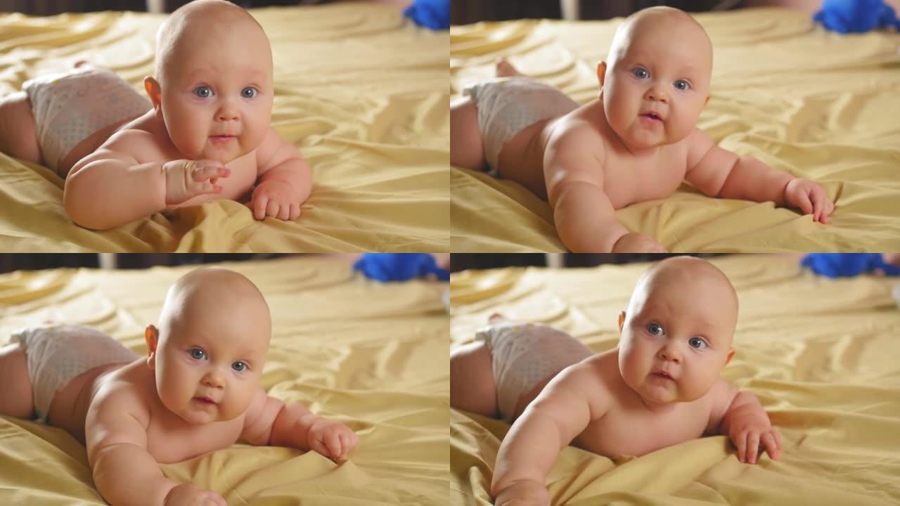 一个胖乎乎的四个月大的婴儿躺在沙发上的肚子上。特写镜头。