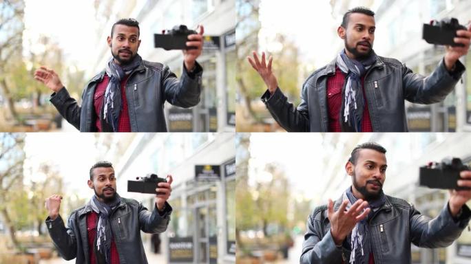 男子在城市用相机拍摄vlog