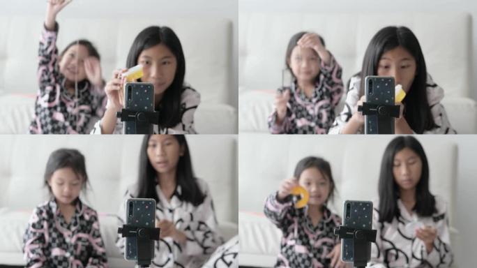 亚洲儿童Vlogging或Youtuber在家里的地板上评论水晶粘液，现代生活方式的概念。