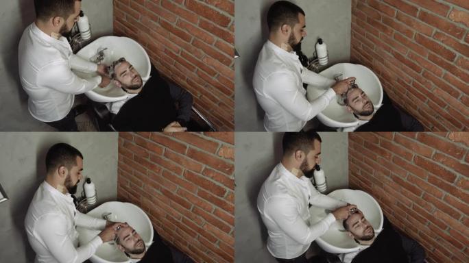 一名身份不明的男理发师的手剪掉一名男子头发的特写镜头
