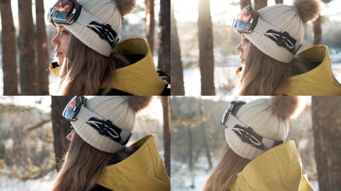冬天在森林里戴着白帽子和背包的女孩