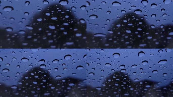 雨滴在挡风玻璃上，以自然为背景，看起来清新，为背景和文字。