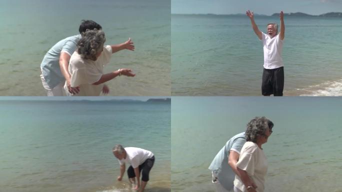 男人和父母在沙滩上玩水