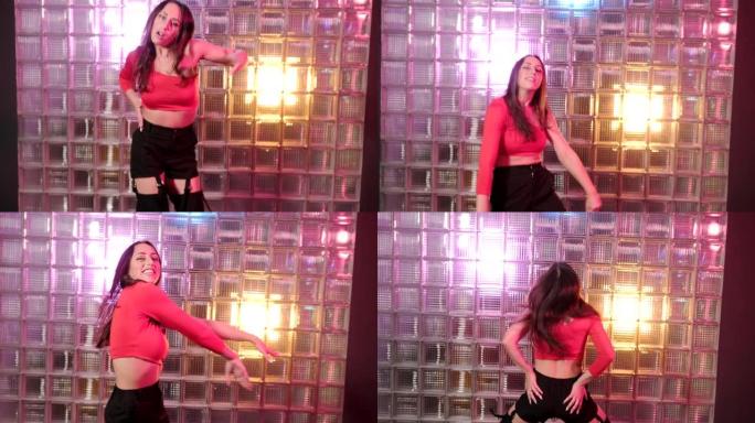 性感的长发年轻女子跳着现代舞，在工作室里表演塑料动作。慢动作。