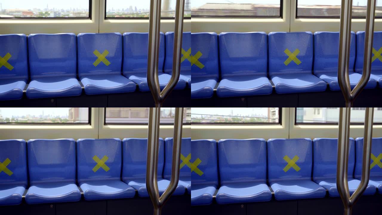 泰国曼谷一列火车的座位上贴了十字贴纸，以保持社交距离