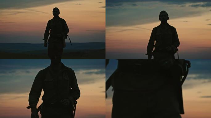 身着制服的士兵在夕阳的映衬下走向摄像机，穿过开阔的乡村