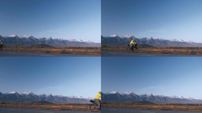 该名男子乘坐混合地形自行车旅行，并乘坐自行车旅行。旅行者带着自行车包旅行。体育旅游自行车包装。