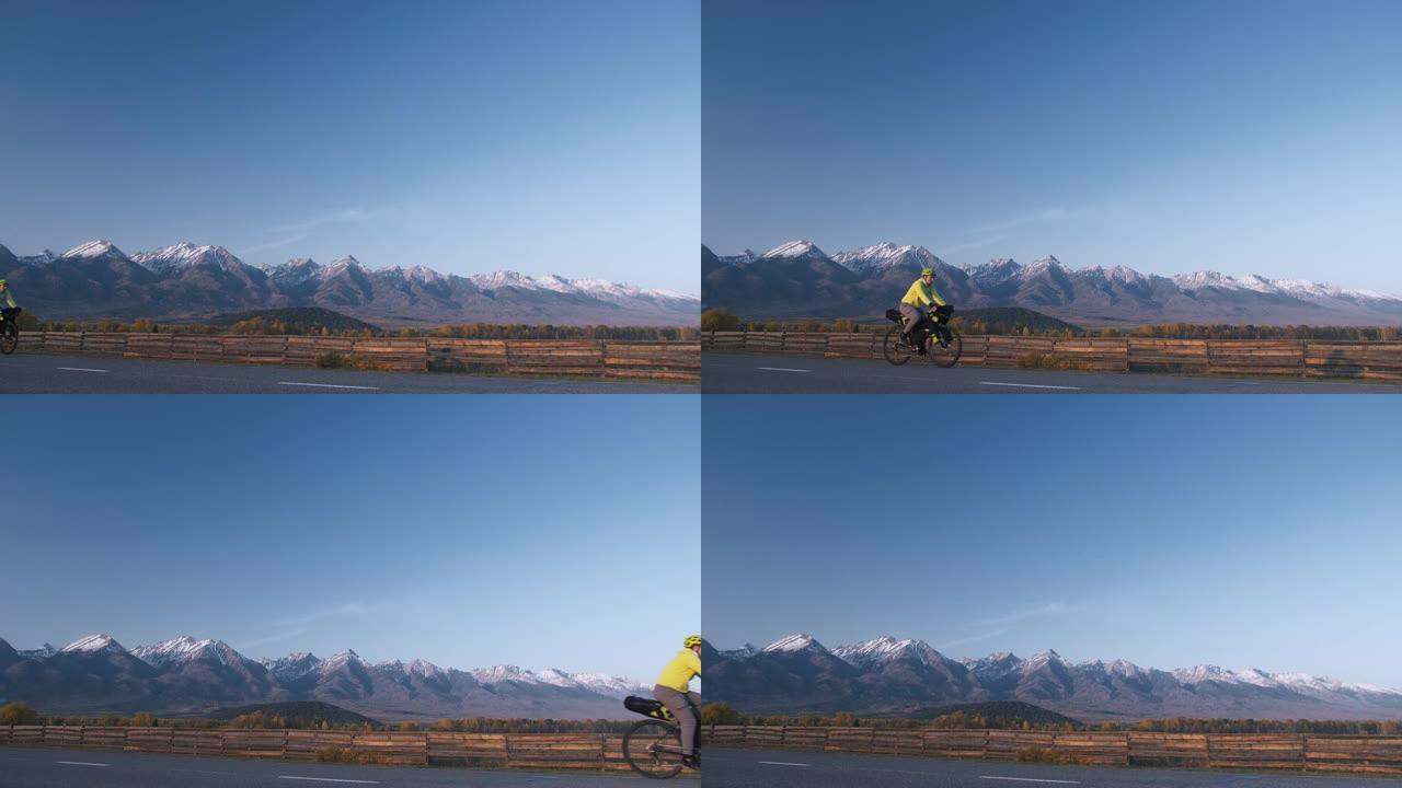 该名男子乘坐混合地形自行车旅行，并乘坐自行车旅行。旅行者带着自行车包旅行。体育旅游自行车包装。