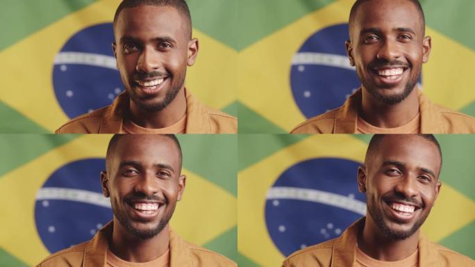 微笑的黑人男子在巴西国旗上摆姿势