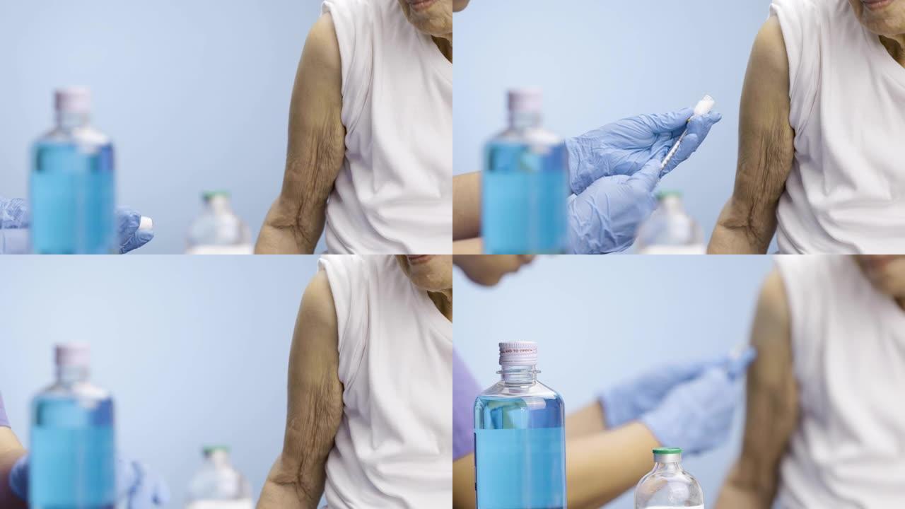 特写护士给资深女性注射疫苗。