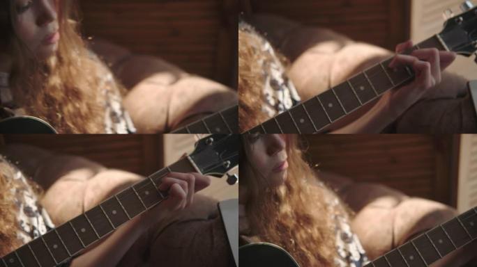 有创造力的女人弹吉他，在指板上夹弦
