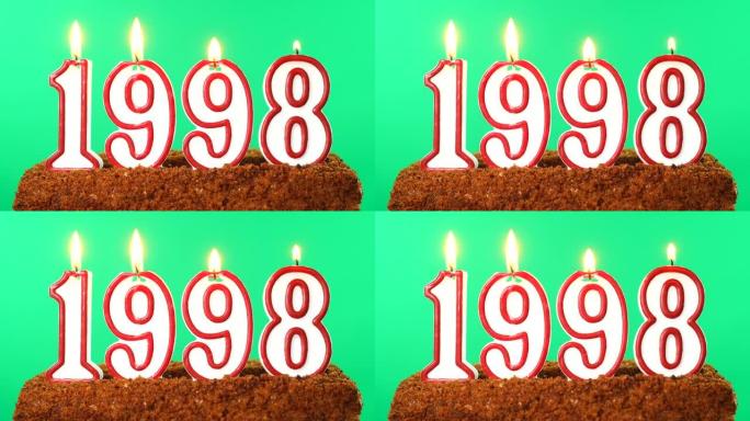 蛋糕与数字1998点燃的蜡烛。上个世纪的日期。色度键。绿屏。隔离