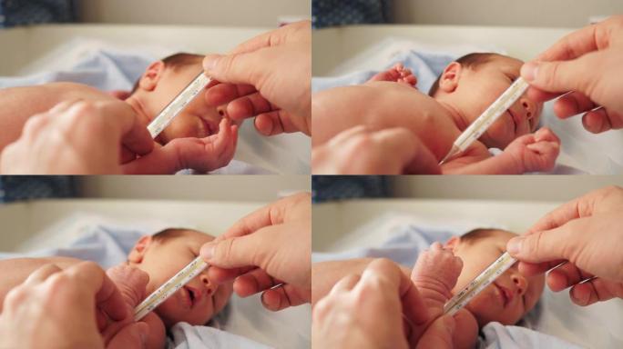母亲或父亲用水银温度计测量婴儿体温。这个孩子几个月大。婴儿体温正常。孩子的皮肤干燥。