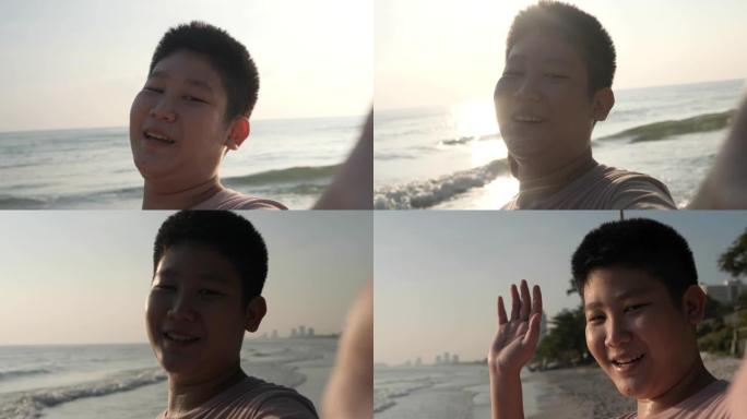 快乐的亚洲儿童早上在海滩上自拍照片或视频通话，生活方式理念。
