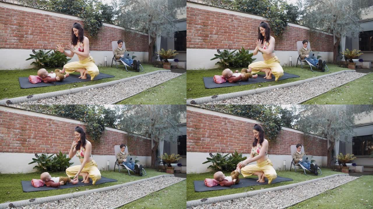 一个有孩子的家庭在后院度过的慢动作视频 -- 妈妈正在练习瑜伽，爸爸在家用笔记本电脑工作