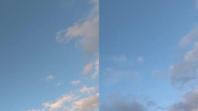 蓬松的白云在延时中快速移动。田园诗般的云天背景。美丽的云在晚上的蓝天。日落,蓝色的小时。垂直视频。