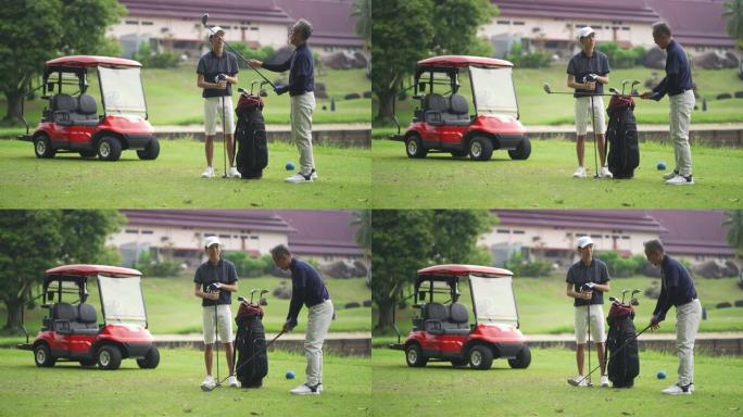 亚裔华裔父亲教儿子在高尔夫球场打高尔夫球