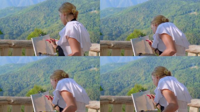 女艺术家在观景台画山