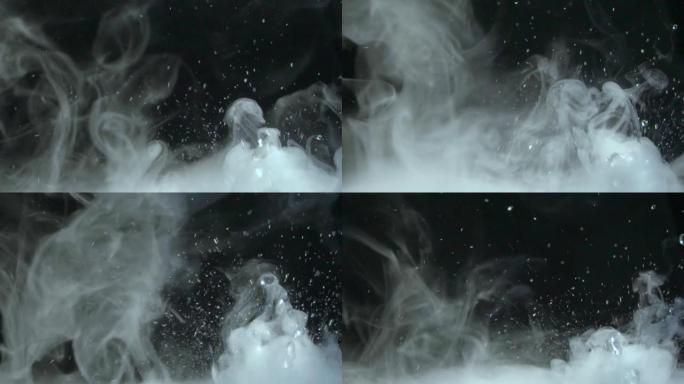 飞溅，飞溅，滴落和飞溅的水与蒸汽close-up.Slow-motion视频，具有循环的能力。旋转滴