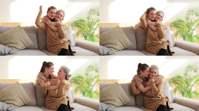 快乐充满爱心的成熟母亲拥抱女儿说话享受温柔的时刻。