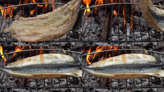 鲭鱼鱼片在烤架上用厨房钳子和抹刀翻转