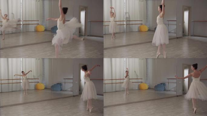 慢动作镜头。迷人的芭蕾舞女演员跳了一个美丽的跳跃，继续她的舞步和旋转