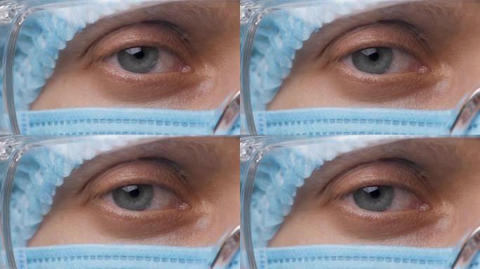 女医生半脸，眼睛戴着安全眼镜。健康员工看着相机。肖像医学研究者女性在医院或诊所佩戴防护装置和护目镜。