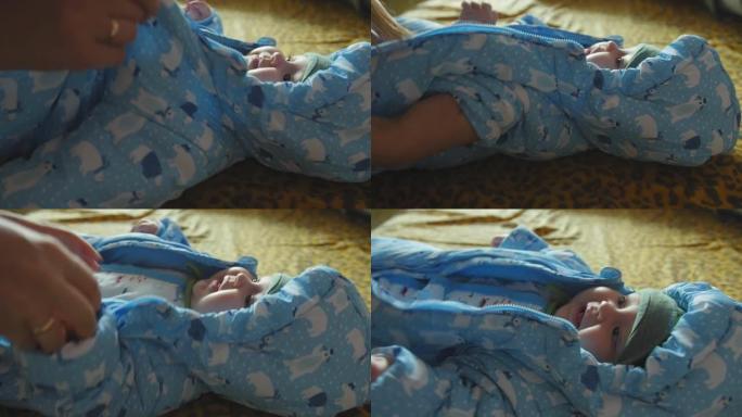 微笑的宝贝躺在床上。妈妈给婴儿穿衣服去散步。特写镜头。